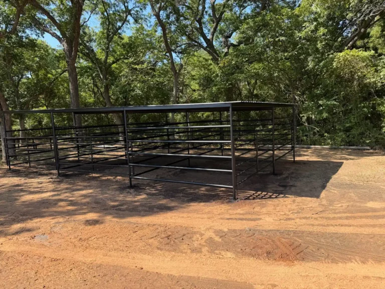 Covered horse stalls under shade trees at Longhorn Landing RV Park
